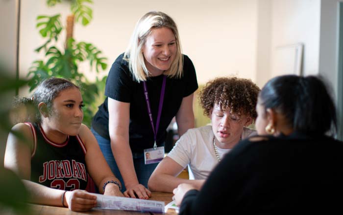 An educator talking to 3 young people